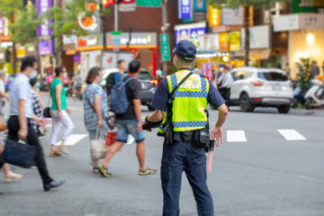 The police patrolling at the crossroads to guard the safety of the people