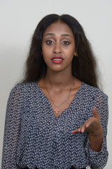 Portrait of young beautiful African woman against white background