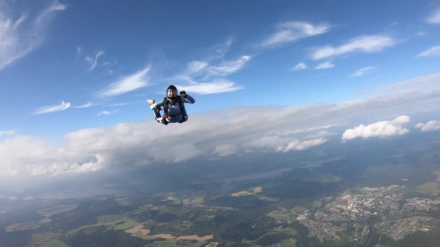 Skydiving. A military girl is flying in the sky.