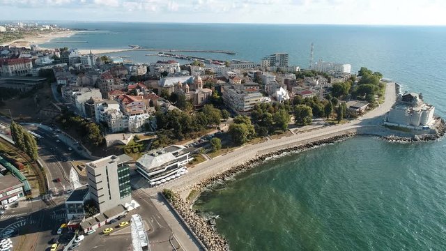Aerial footage of a Ferris wheel in a sunny morning by the sea