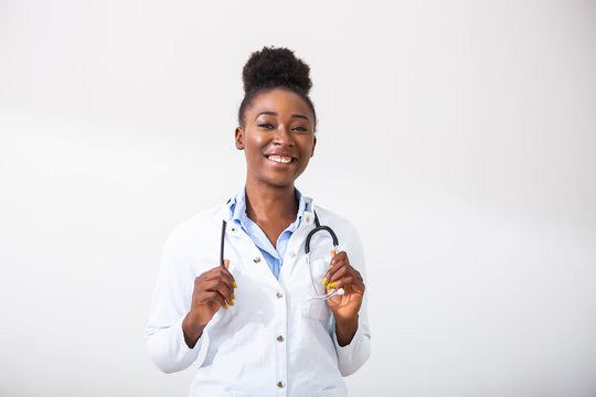 Confident smiling doctor posing and looking at camera with stethoscope in her hands. Friendly African American female doctor smiling. Doctor with stethoscope around her neck
