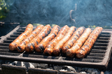Sausages on the charcoal. BBQ outdoor. Fried meat sausages