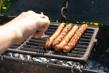 Sausages on the charcoal. BBQ outdoor. Fried meat sausages