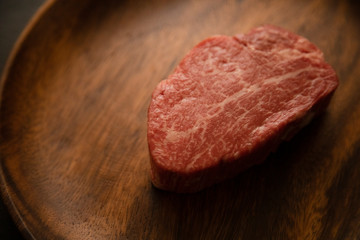 Raw meat on the wooden plate