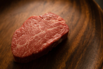 Raw meat on the wooden plate