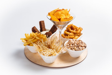 Isolated beer snacks set on a round wooden board