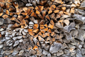 Firewoods are piled up in the backyard.
