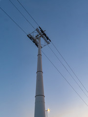 Power tower on a clear blue sky at night