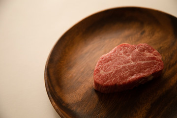 Raw meat on the wooden plate
