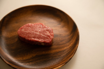 Raw meat on the wooden plate
