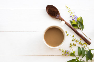 hot instant coffee with mushed coffee in wooden spoon arrangement flat lay style on background white wooden