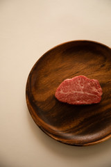 Raw meat on the wooden plate