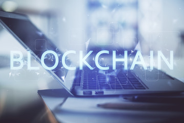 Double exposure of blockchain and crypto economy theme hologram and table with computer background. Concept of bitcoin cryptocurrency.