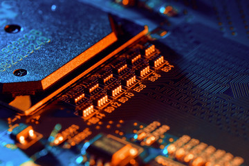 Electronic circuit board with electronic components such as chips close up. Blurry background.	
