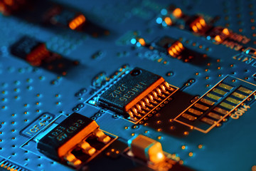 Electronic circuit board with electronic components such as chips close up. Blurry background.	