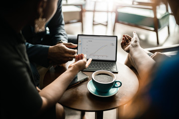 Businesspeople going over graphs on a tablet during a meeting