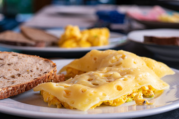 scrambled eggs with chesse and bread with blurred background
