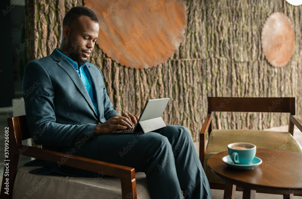 Wall mural North African businessman using a digital tablet in an office