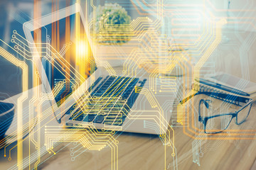 Double exposure of desktop with computer and world map hologram. International data network concept.