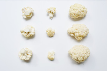 Set of pieces of cauliflower on a gray background