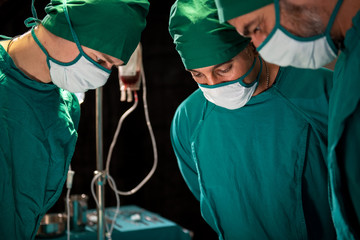 Group and teamwork of surgeons in hospital operating theater. Teamwork medical doctor working  performing surgery