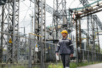 An engineering employee makes a tour and inspection of a modern electrical substation. Energy....