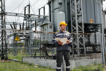 The energy engineer inspects the equipment of the substation. Power engineering. Industry