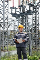 The energy engineer inspects the equipment of the substation. Power engineering. Industry