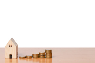 Money coin saving with a wooden home model isolated on white background.