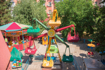 Fototapeta na wymiar Colorful children's rides in the park