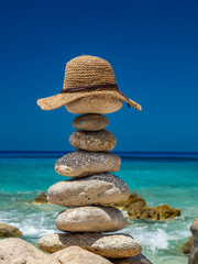 Straw Sunhat at the beach on stones
