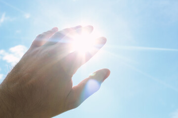 Hand covering the bright sun. Background. Texture.