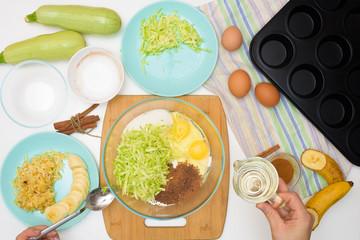 step by step recipe and ingredients for chocolate muffins with zucchini and banana. wet veggie cupcakes home-made, top view on a light background. the process of cooking muffins