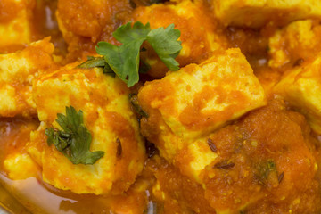 Home made recepie of kadahi paneer or paneer butter masala served in a brass bowl isolated on white available with clipping mask