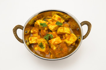 Home made recepie of kadahi paneer or paneer butter masala served in a brass bowl isolated on white available with clipping mask