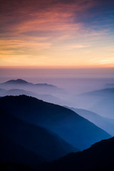 Fototapeta na wymiar Layers of magnificent mountains at sunset with colorful clouds background. Hehuan Mountain in Taiwan, Asia. Taiwan Central Mountain Range.
