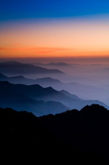 Layers of magnificent mountains at sunset with colorful clouds background. Hehuan Mountain in Taiwan, Asia. Taiwan Central Mountain Range.