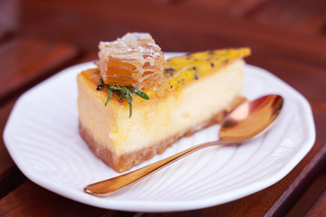 A piece of passion fruit cake with honeycomb on white plate.