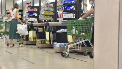 young woman with a prosthetic leg does her shopping at the supermarket