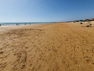 La Barrosa beach in Sancti Petri, Cádiz, with a large amount of sand without water as the tide is low