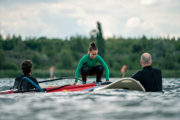Naklejka premium Woman learning winsurfing on the Markkleeberger Lake near Leipzig