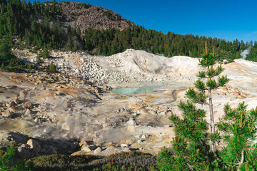 Lassen Volcanic National Park. Rocky trail with grand vistas descends to a boardwalk through Lassen's largest hydrothermal area. Trailhead at Bumpass Hell Parking area.