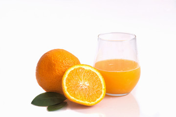 Two apsins and orange juice in a glass on a white background isolate