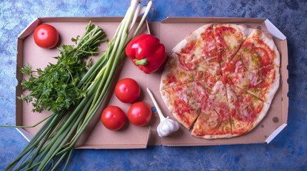 Tasty pizza and fresh vegetables