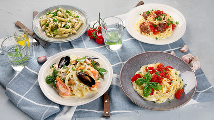 Plates of pastas with different kinds of sauces.