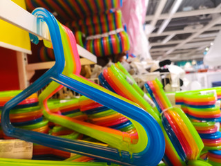 Fototapeta na wymiar a set of plastic multicolored hangers for sale in a shopping center