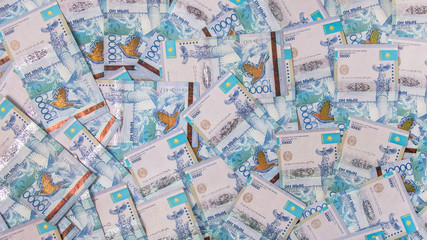 Fototapeta na wymiar Background in Kazakhstani tenge. A lot of Kazakhstan money. Sawing the budget, the subsistence minimum or the dual currency basket in Kazakhstan.The crisis is caused by the fall in exchange rates.