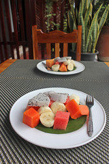 A portion of mixed tropical fruit salad served on a plate on a table