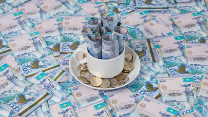Fototapeta na wymiar Background in Kazakhstani tenge. A lot of Kazakh money. Sawing the budget, the subsistence minimum or the dual currency basket in Kazakhstan.The crisis is caused by the fall in exchange rates.