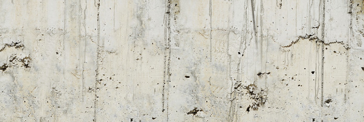 Concrete wall. Weathered old paints on the spilled wall.